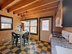 Kitchen and dining area is fully equipped and has a door that leads to the back deck